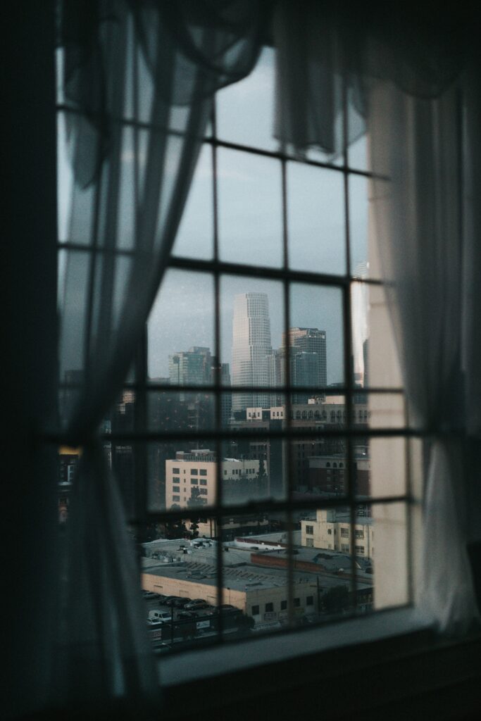 Blurred city street with traffic seen from a window, conveying ambient urban sound