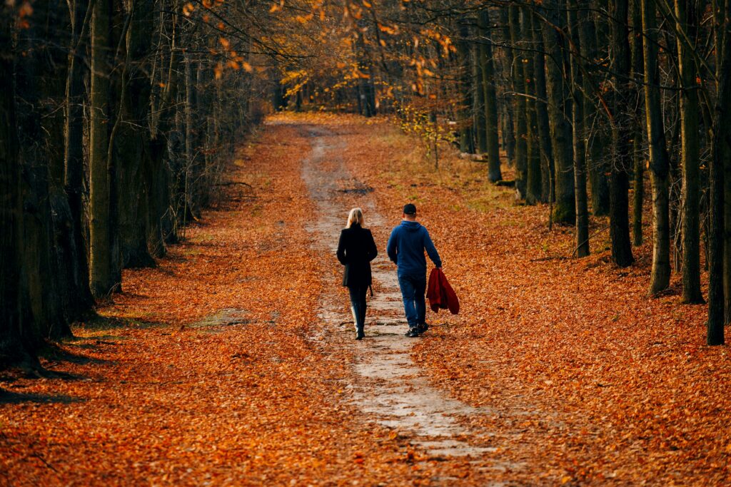 A couple walking together on a quiet morning — the season before conception begins again roughly every three months