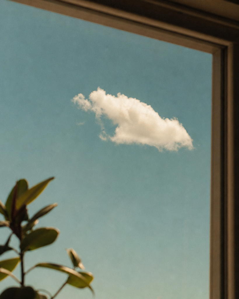 A single cloud crossing an open sky — the image of letting a thought pass instead of chasing it